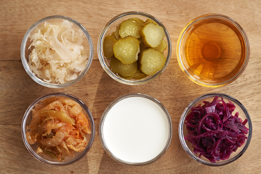 Fermented foods and vegetables - kimchi, white and purple sauerkraut, apple cider vinegar, gherkins and kefir