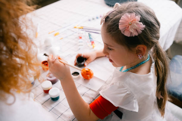 istock Little girl painting the egg , preparing for Easter at home 2020893973