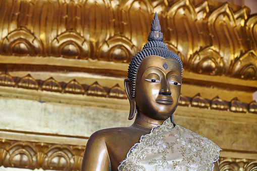 Ancient Buddha statue wearing a cerimonial robe at Wihan Phra Mongkhon Bophit temple. Ayutthaya. Phra Nakhon Si Ayutthaya province. Thailand.