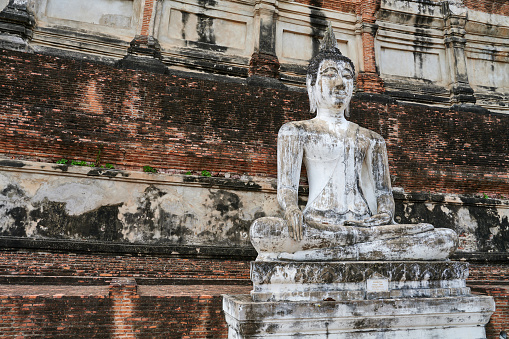 Ancient Buddha statue in lotus position at Yai Chai Mongkhon temple. Ayutthaya. Phra Nakhon Si Ayutthaya province. Thailand.