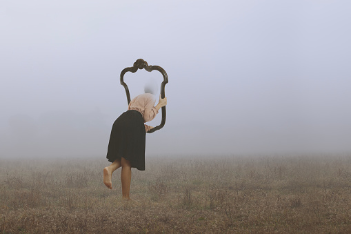 surreal journey of a woman who escapes from the real world through a frame immersed in fog, abstract concept