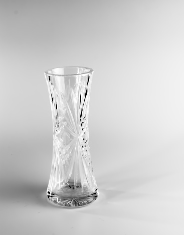 Empty crystal vase on white background. The vase was made in the mid-20th century.