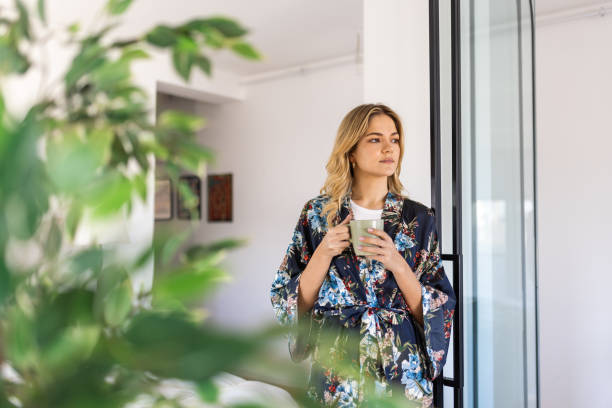 istock A young woman relaxing and drinking tea or coffee at home 2021001207