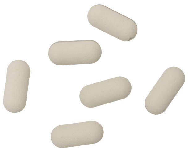White oval tablet on isolated background, close up