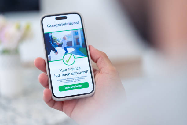 istock Man holding a digital with mortgage loan application approval. 2021005419