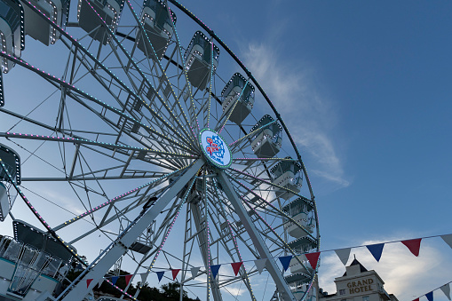 Llandudno north Wales united kingdom 02 June 2023 Llandudno pier Ferris wheel under the blue sky at dusk