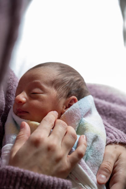 istock mother looking at her newborn with love 2021089903