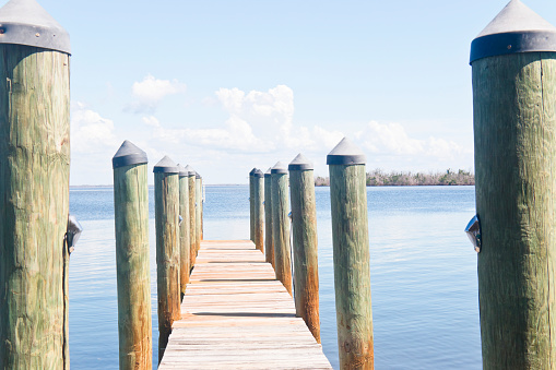 Long empty jetty on the Caloosahatchee River which flows into the Gulf of Mexico on Sanibel Island, Florida, USA. in Florida, USA.