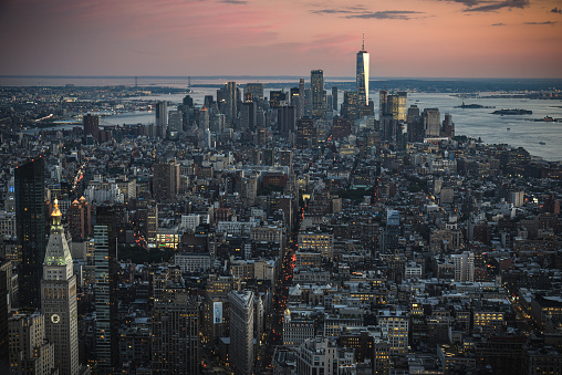 New York, NY, USA - August 8, 2017: Manhattan skyline seen from the top of the Empire State Building at dusk.