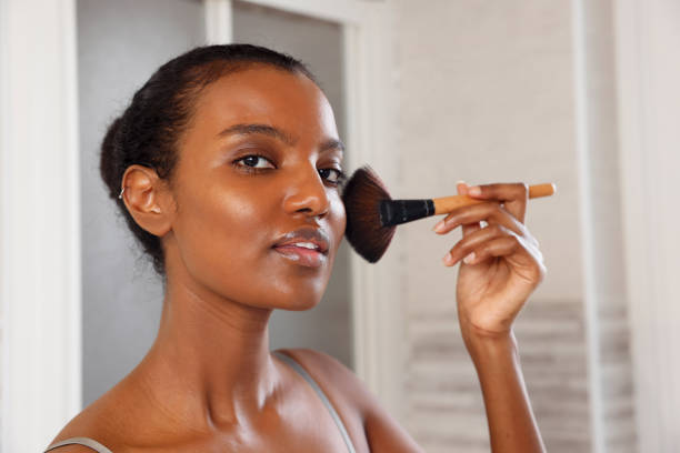 Beautiful African American Woman Applying Make up