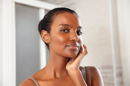 Beautiful African American Woman Done Putting Simple and Elegant Make up in the Morning
