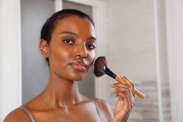 istock Fierce Beautiful African American Woman Applying Make up 2021129595