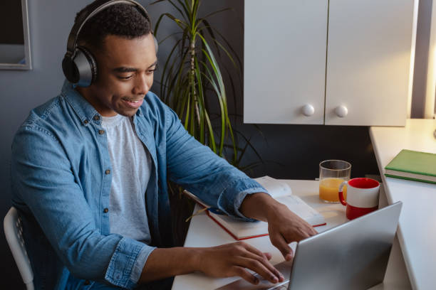 istock Young African American man working at home on laptop 2021135877