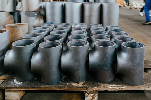 Batch of T shape pipe parts in factory.