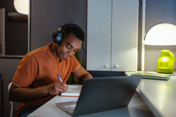 Young man concentrating on work. Working late at home