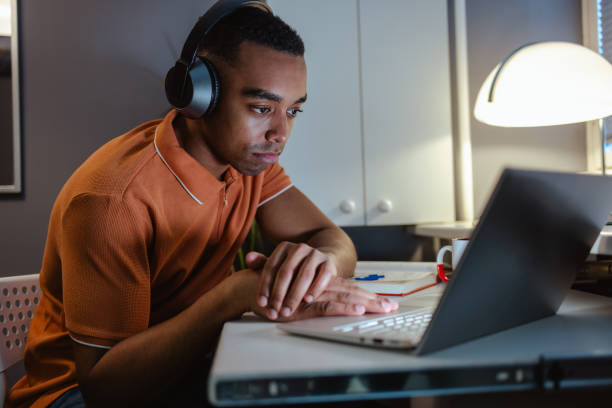 istock Tired young man working late at home 2021146240