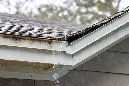Water trickling off a roof during a storm.