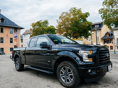 Chambery, France - Aug 15, 2017: Front view of new F-150 Ford a light-duty truck marketed as full-size pickup trucks parked in public parking
