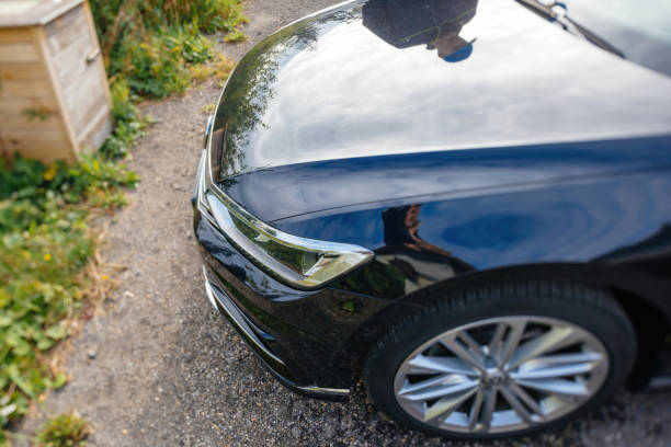 Mummelsee, Germany - Sep 21, 2018: View from above at the Volkswagen Passat car - tilt-shift lens used focus on the led new technology lights and reflection of the driver in the shiny surface