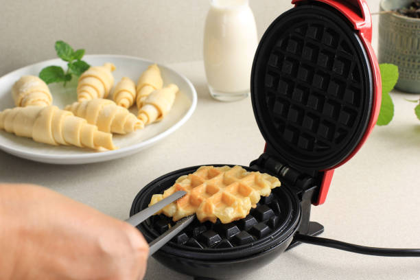 istock Preparation Process Making Croissant Waffle or Croffle from Frozen Croissant Dough using Electric Waffle Maker 2021238466
