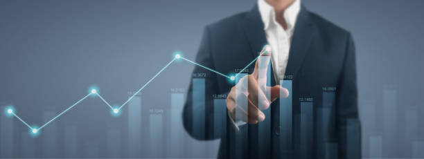 istock Businessman with chart financial symbols coming from hand 2021256266