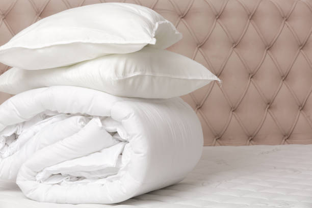 istock Soft folded duvet and pillows on bed 2021275386
