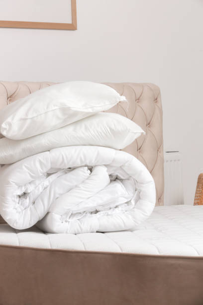 istock Soft folded duvet and pillows on bed 2021275387