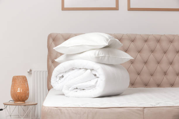 istock Soft folded duvet and pillows on bed 2021275389