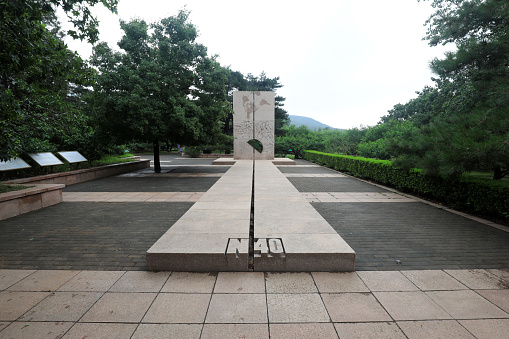 Beijing, China - June 26, 2021: geographical indication sculpture at 40 degrees north latitude of Beijing Botanical Garden
