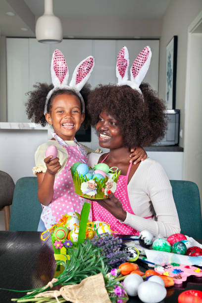 istock Cute Multiracial family, mother and daughter preparing for Easter celebration 2021298870