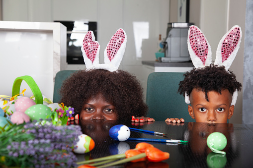 Happy Multiracial family at Easter having fun in living room