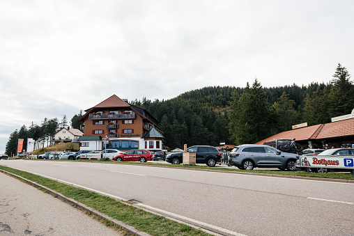 Mummelsee, Germany - Sep 21, 2019: Large view of Berghotel Mummelsee 1036m in German Black Forest with multiple cars parked in front