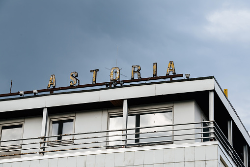 Kehl, Germany - July 30, 2017: Rusty old vintage signage on the roof of hotel Astoria