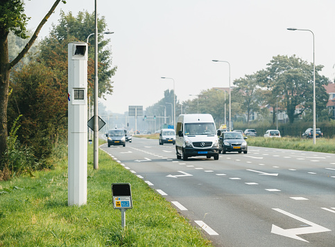 Haarlem, Netherlands - Aug 28, 2019: Side view of speed meter on the side of the Dutch highway with fast cars driving