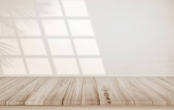 istock Minimalistic abstract gentle light beige background for product presentation with light and shadow of window and leaf curtains on wall. Pastel cream watercolor concrete wall old on floor wood parquet. 2021348220