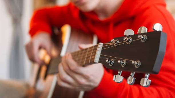 Guitar tuning music hobby man hands adjusting pegs