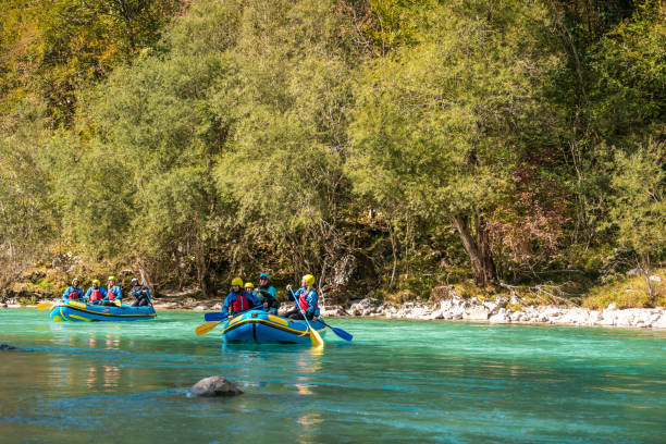 istock Group of People Navigating River Rapids in a Lush Environment 2021351749