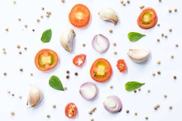 istock tomatoes, garlic ,shallots and basil isolated on white background, top view 2021363289