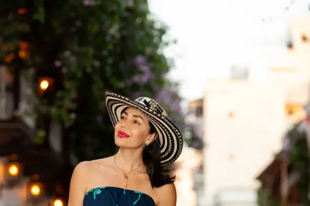 Beautiful woman wearing the traditional Colombian hat called Sombrero Vueltiao at the historical streets of the Cartagena de Indias walled city