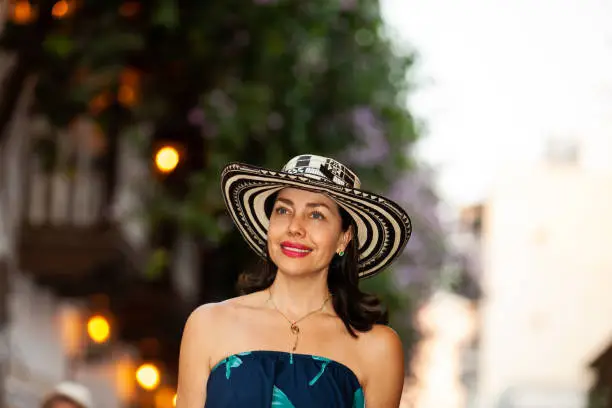 Beautiful woman wearing the traditional Colombian hat called Sombrero Vueltiao at the historical streets of the Cartagena de Indias walled city