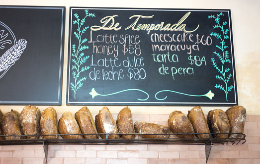 Oaxaca, Mexico: A blackboard menu and a row of sourdough bread at Boulenc cafe in downtown Oaxaca.