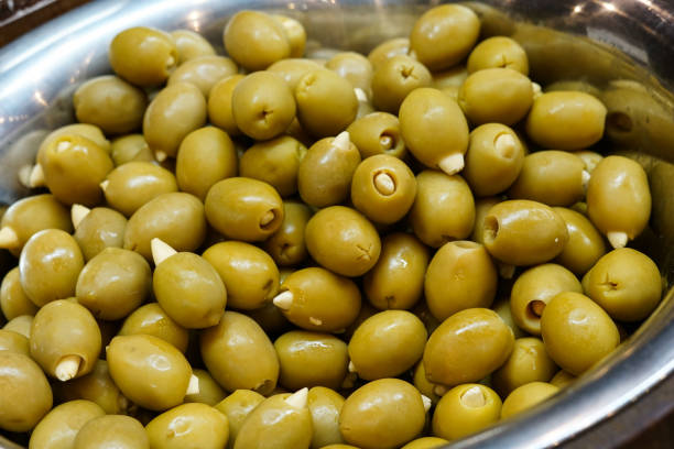 istock Green olives in a silver bowl. 2021434112