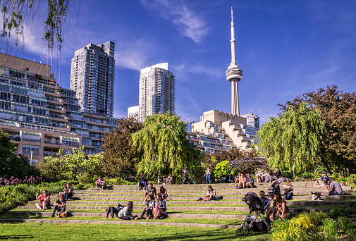 Toronto, Canada - 06 09 2019: Torontonians having rest in the Music Garden. Toronto Music Garden, one of the city's most enchanted locations, is inspired by Bach's First Suite for Unaccompanied Cello.