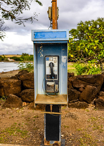 A phone booth remains in working order at a beach in Kauai Hawaii