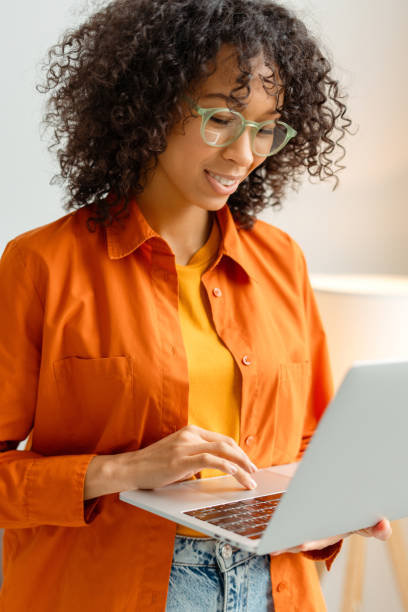 istock Attractive business woman, freelancer, copywriter using laptop typing on keyboard working from home 2021504765
