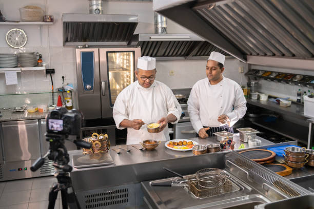 Arab chef in cook uniform frying meat with vegetables on pan outdoors