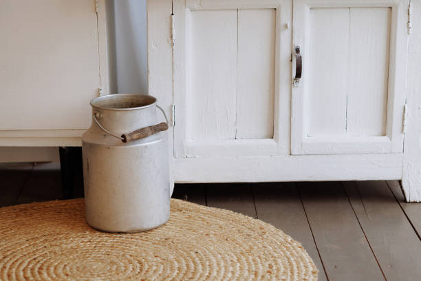 five opened milk cans waiting for being picked up by the farmer