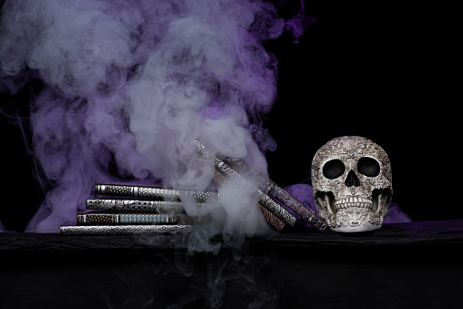Handmade skull and book covers with dramatic smoke background homemade by photographer Thailand Asia