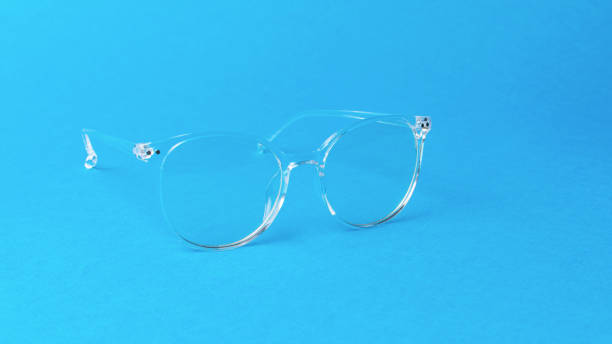 istock Elegant transparent glasses on a blue background. 2021639143