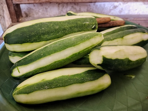 a photo of some partially peeled cucumbers